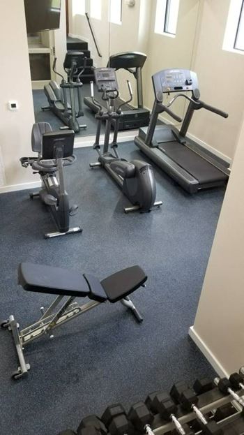 A room filled with lots of different types of exercise equipment